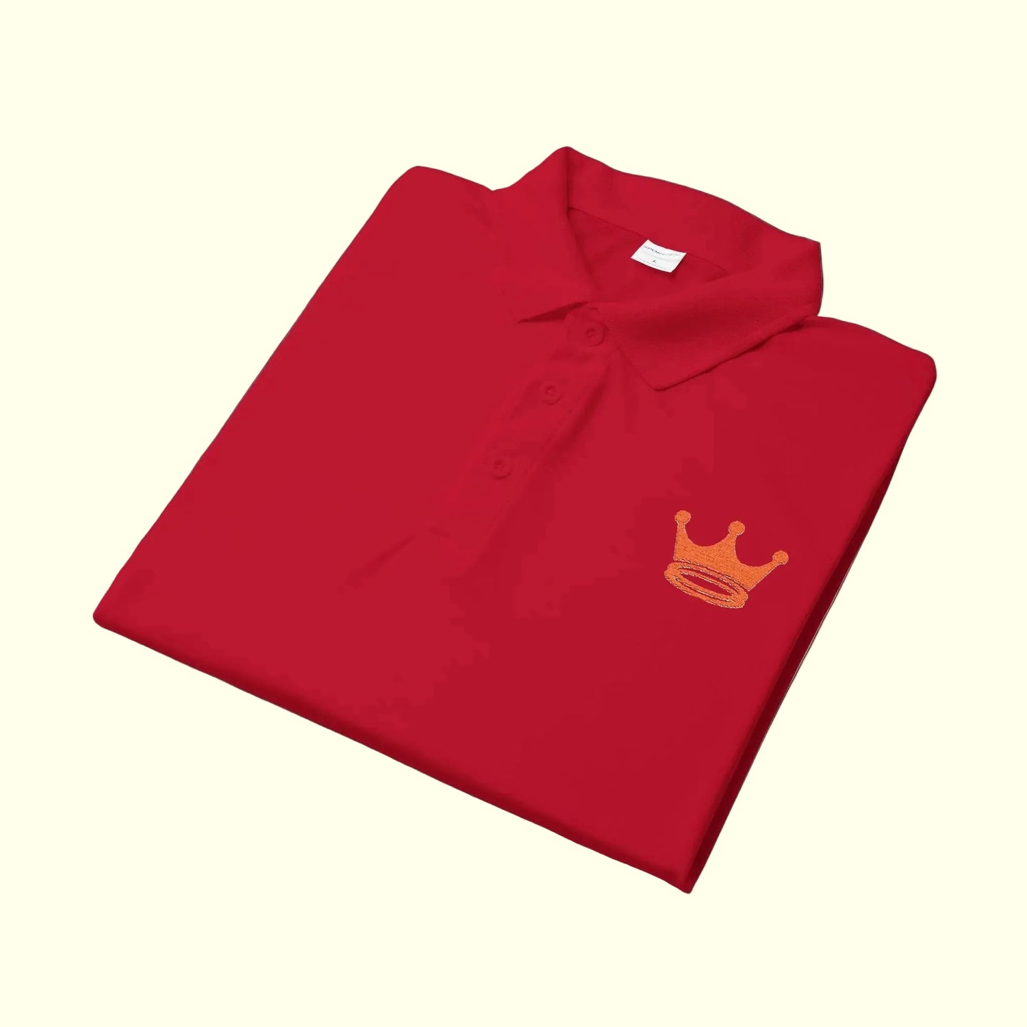 Folded polo shirt with a crown + halos emblem on a white background
