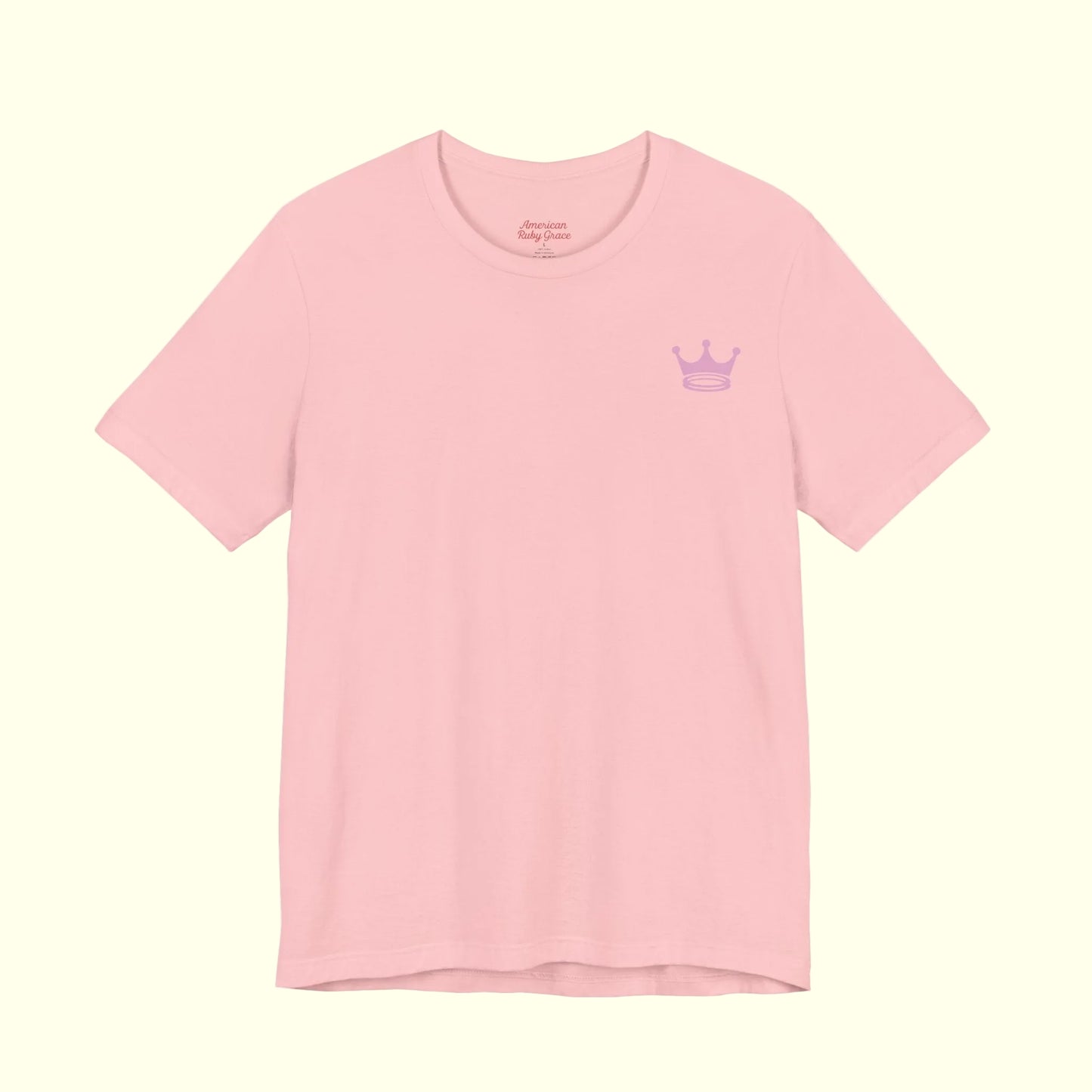 Pink t-shirt with a small logo on a white background