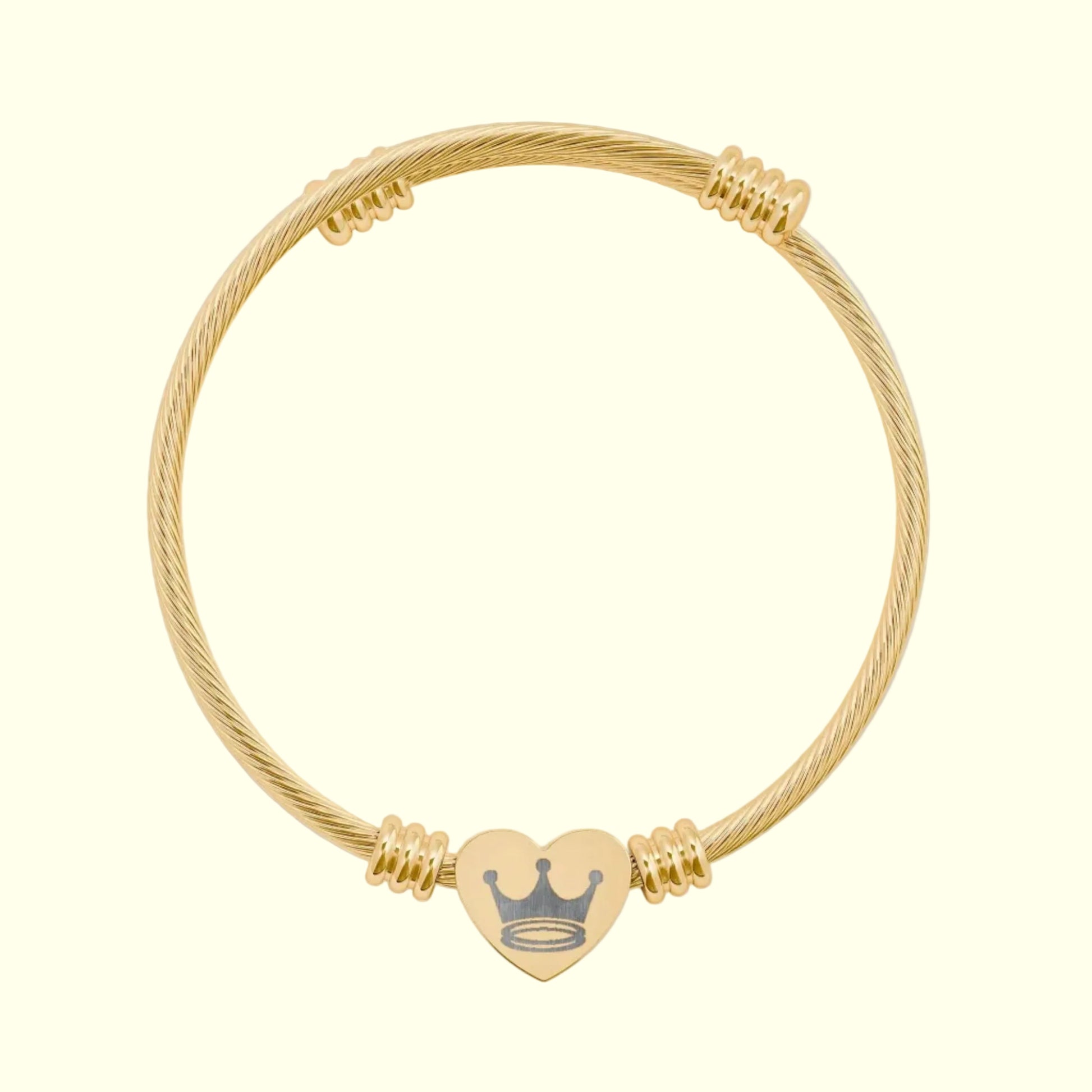Gold bracelet with a heart-shaped charm on a white background
