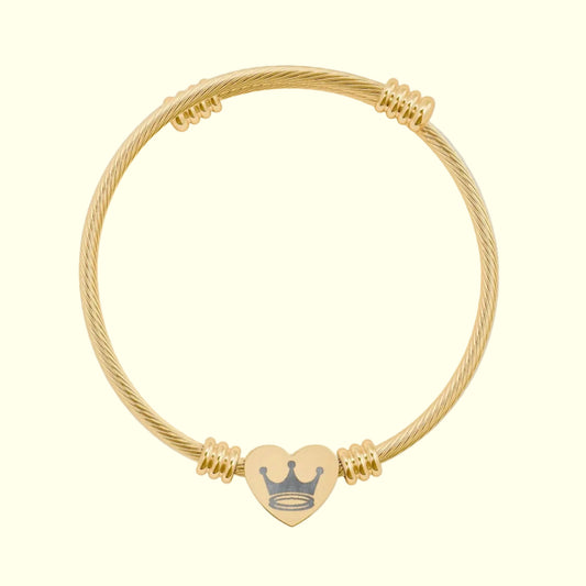 Gold bracelet with a heart-shaped charm on a white background
